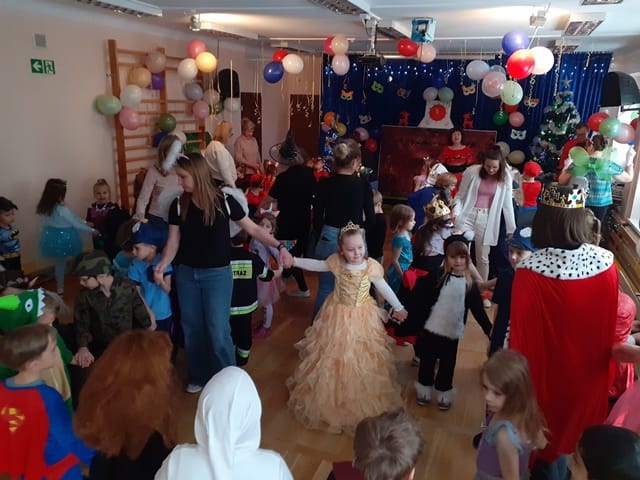 dzieci w przebraniach tańczą na balu